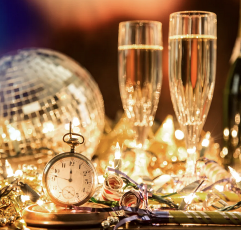 Champagne glasses and a disco and a stopwatch backlit, sparkling