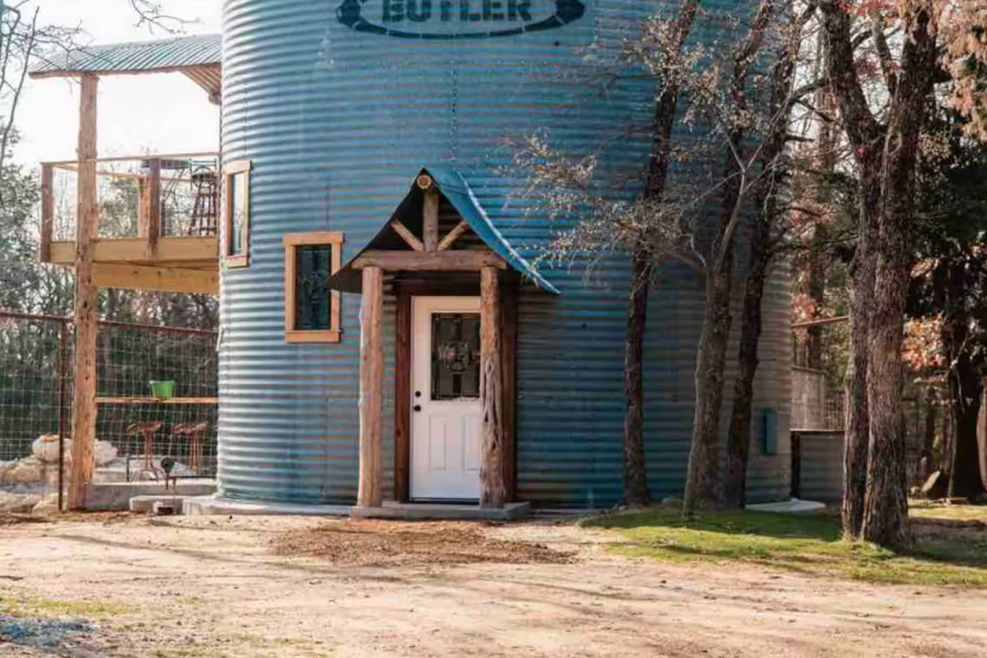 Rustic Silo with a door to a house inside. And a Beautiful side deck on the left